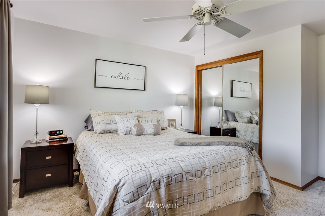 5209 Northeast 3rd Street Renton, WA 98059 - Photo 13 of 31 a bedroom with a bed and a lamp