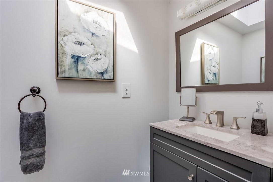 5209 Northeast 3rd Street Renton, WA 98059 - Photo 14 of 31 a bathroom with a sink and a mirror