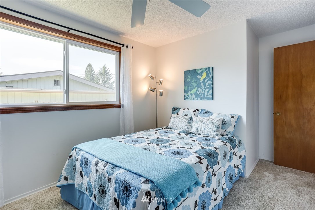 5209 Northeast 3rd Street Renton, WA 98059 - Photo 15 of 31 a bedroom with a bed and a window