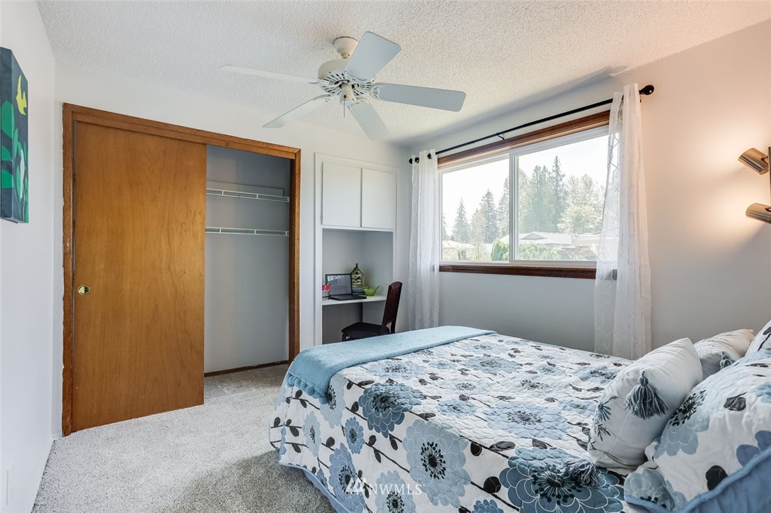 5209 Northeast 3rd Street Renton, WA 98059 - Photo 16 of 31 a bedroom with a large bed and a window
