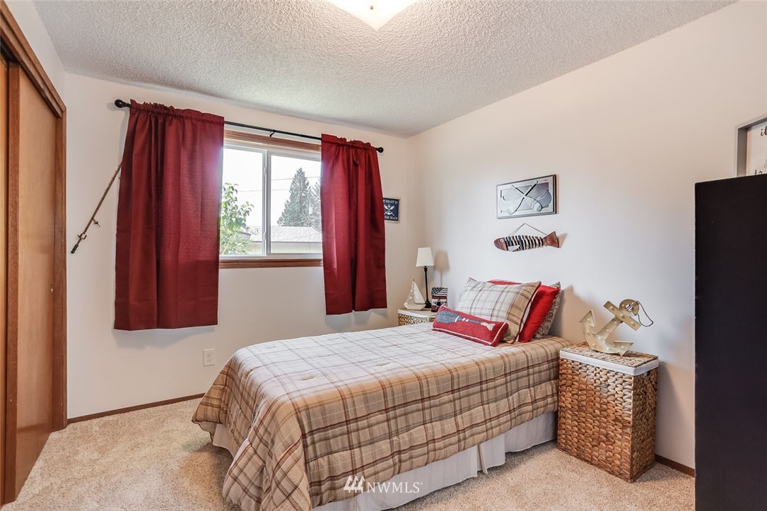 5209 Northeast 3rd Street Renton, WA 98059 - Photo 18 of 31 a bedroom with a bed and a window
