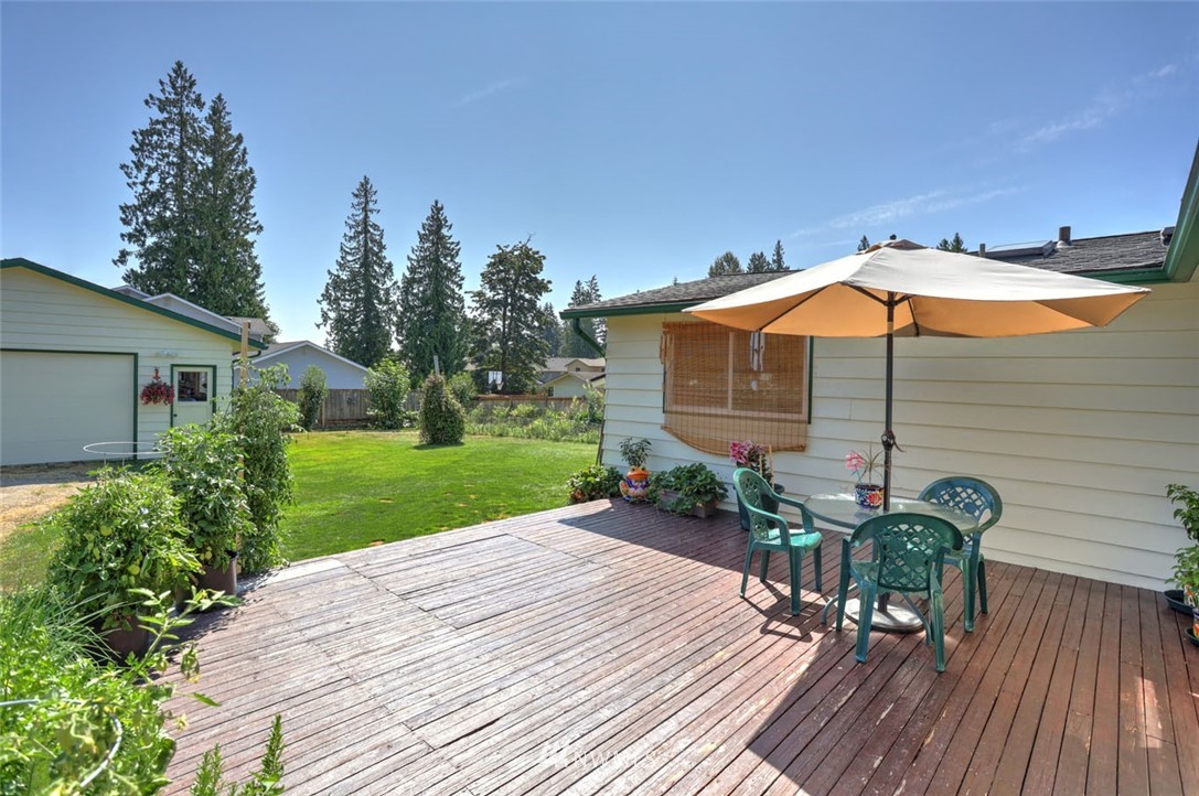 5209 Northeast 3rd Street Renton, WA 98059 - Photo 22 of 31 a view of a chair and table on the wooden deck