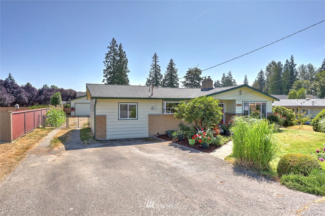 5209 Northeast 3rd Street Renton, WA 98059 - Photo 27 of 31 a view of a house with potted plants and a large tree