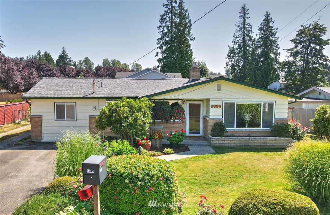 5209 Northeast 3rd Street Renton, WA 98059 - Photo 28 of 31 a view of a house with swimming pool and a garden