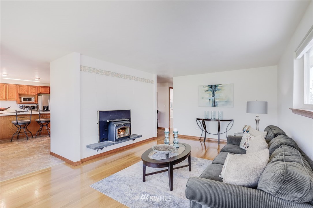 5209 Northeast 3rd Street Renton, WA 98059 - Photo 5 of 31 a living room with furniture and a fireplace