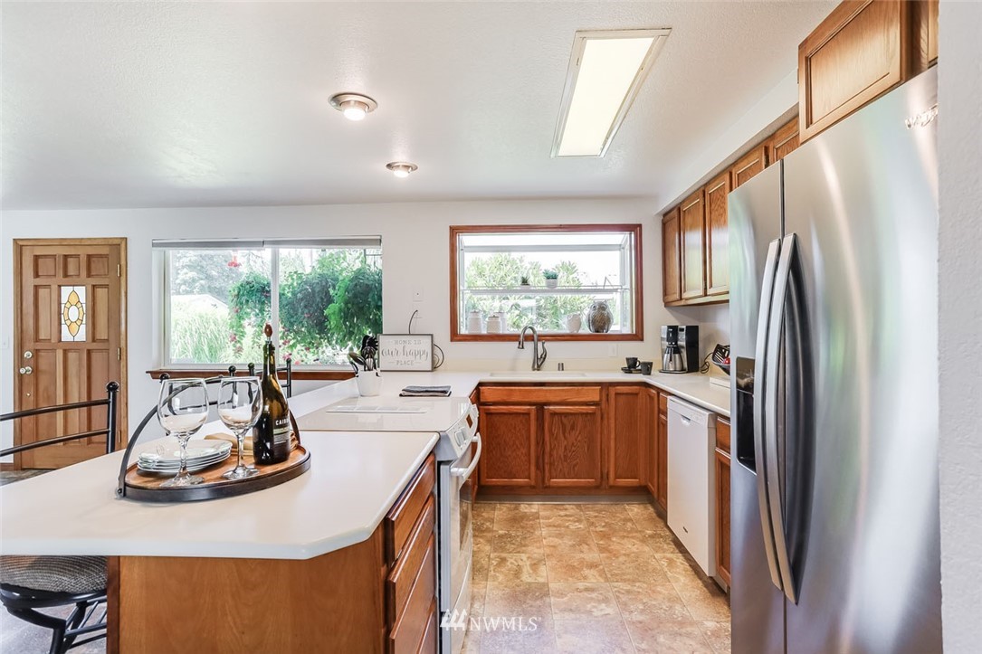 5209 Northeast 3rd Street Renton, WA 98059 - Photo 8 of 31 a kitchen with stainless steel appliances granite countertop a refrigerator sink and stove