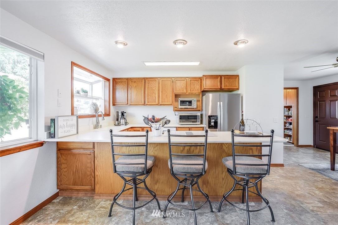 5209 Northeast 3rd Street Renton, WA 98059 - Photo 9 of 31 a kitchen with appliances cabinets and chair