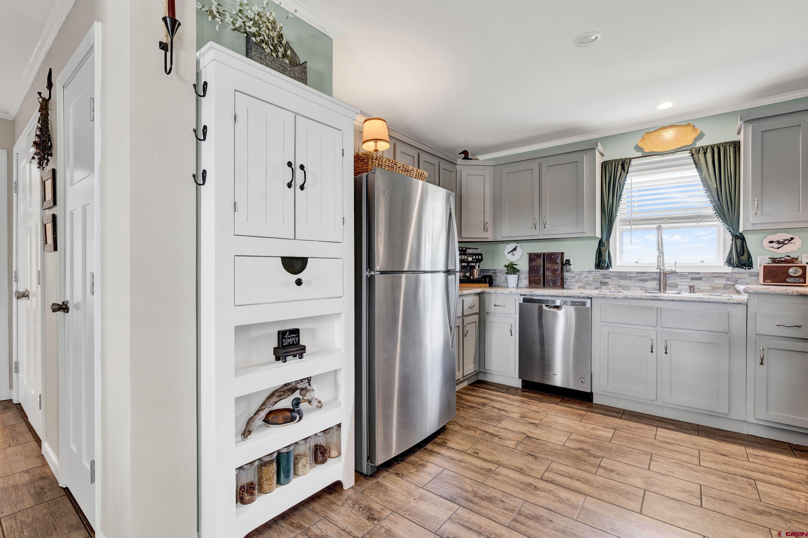 901 6530 Road, Unit 2813 Montrose, CO 81401 - Photo 12 of 34 a kitchen with white cabinets and refrigerator