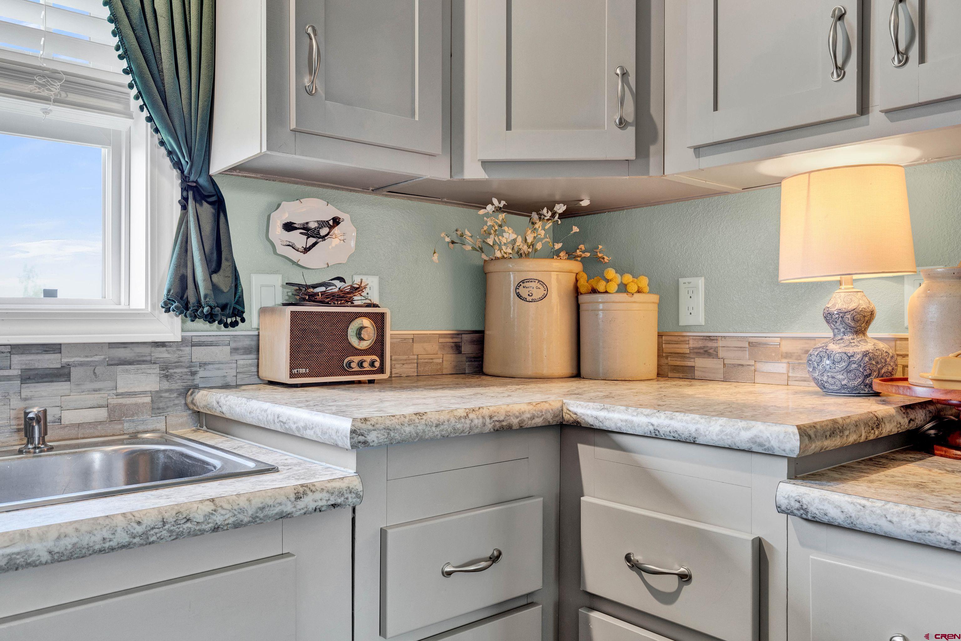 901 6530 Road, Unit 2813 Montrose, CO 81401 - Photo 14 of 34 a kitchen with granite countertop stainless steel appliances sink and cabinets