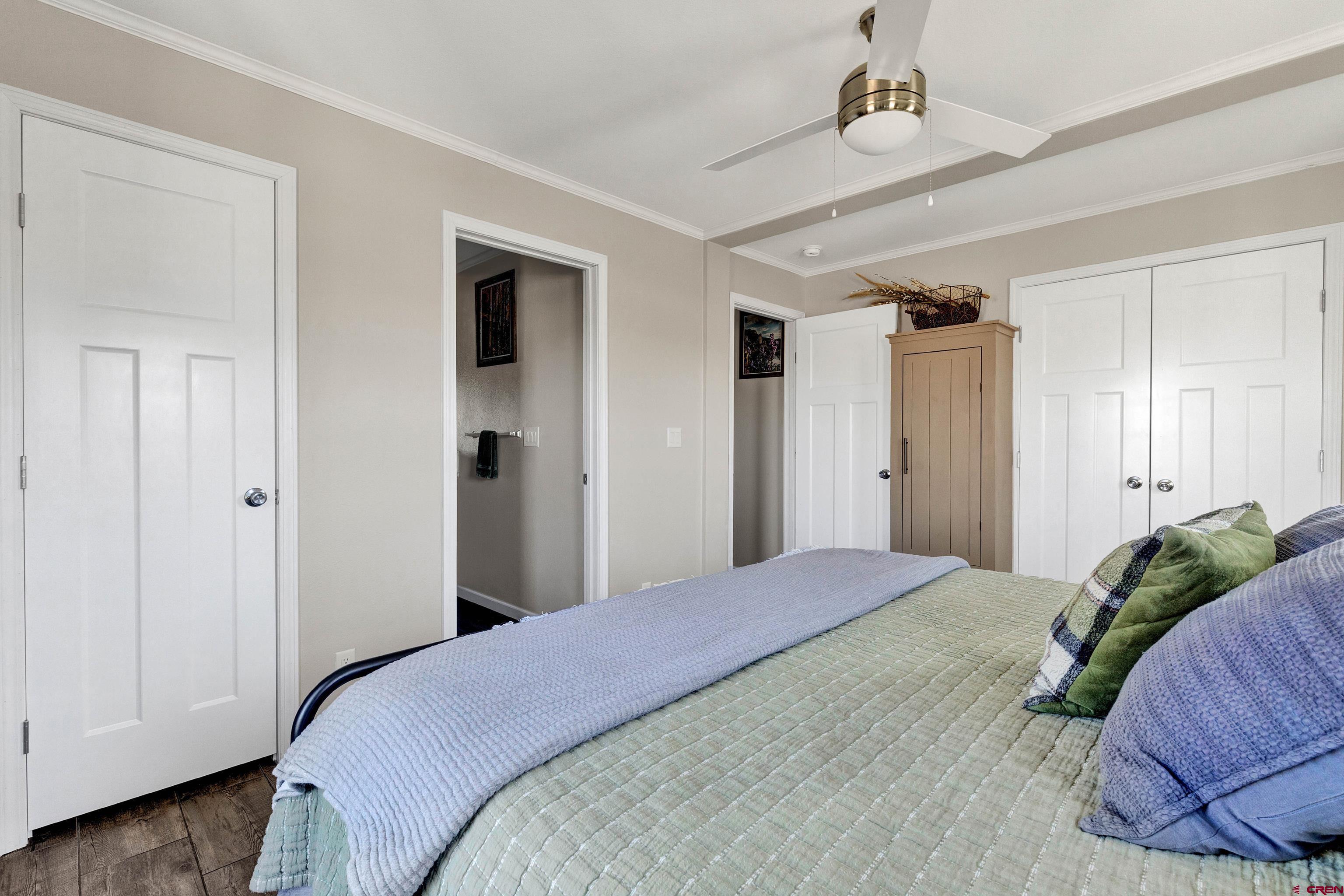 901 6530 Road, Unit 2813 Montrose, CO 81401 - Photo 17 of 34 a bedroom with a bed and a mirror