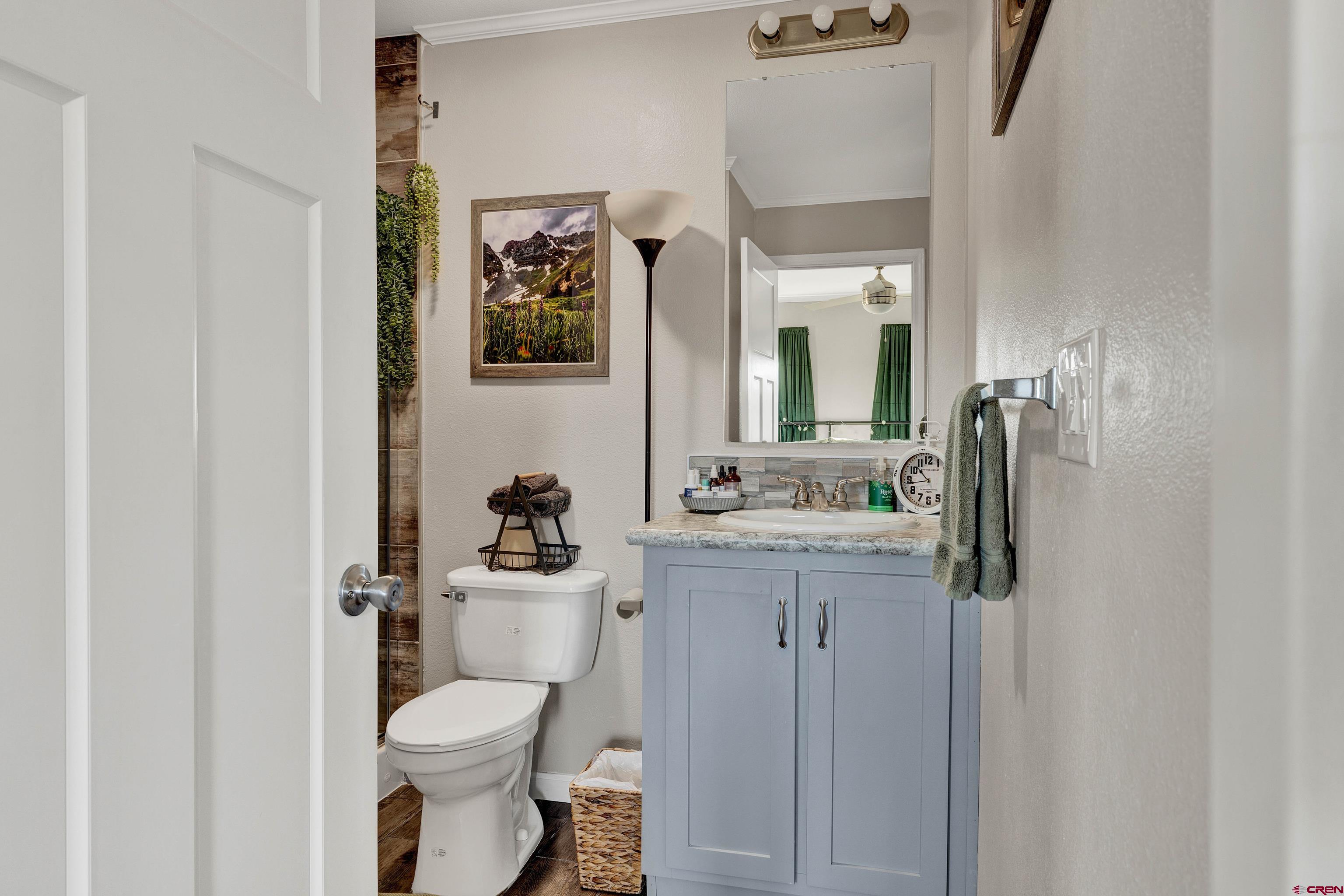 901 6530 Road, Unit 2813 Montrose, CO 81401 - Photo 18 of 34 a bathroom with a toilet sink and mirror
