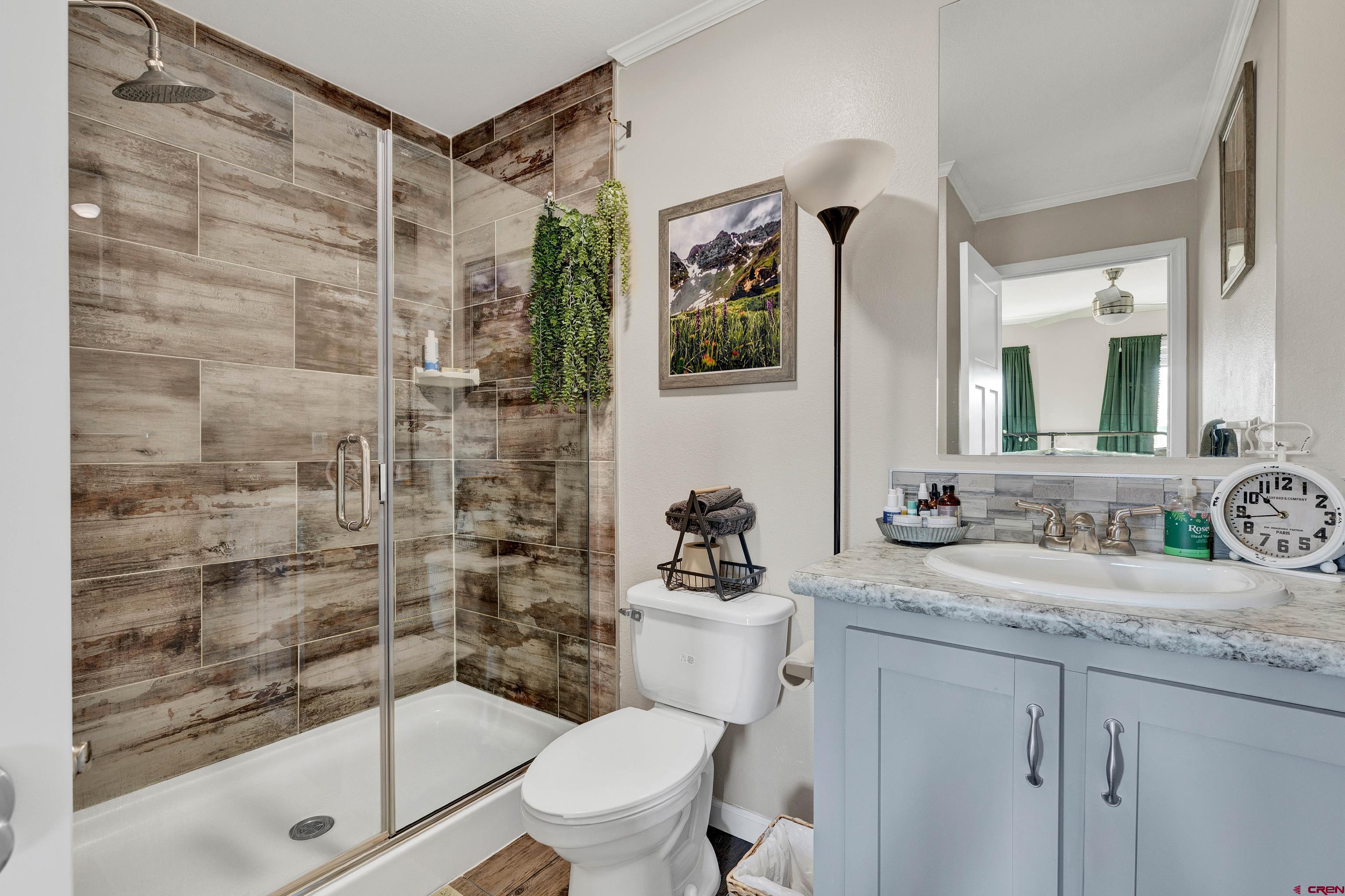 901 6530 Road, Unit 2813 Montrose, CO 81401 - Photo 19 of 34 a bathroom with a sink a toilet and shower