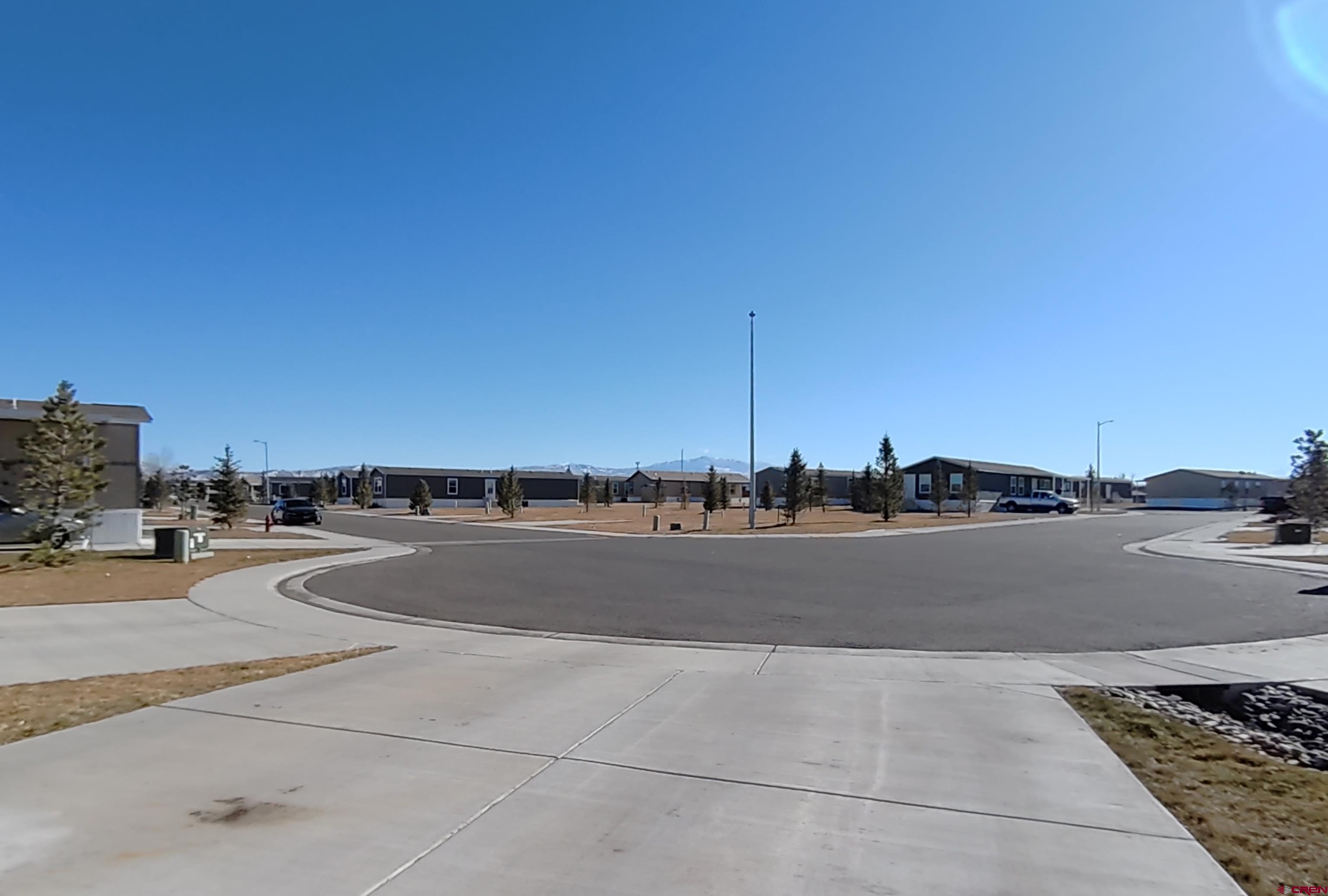 901 6530 Road, Unit 2813 Montrose, CO 81401 - Photo 2 of 34 a view of a terrace with a couple of cars parked in front of it