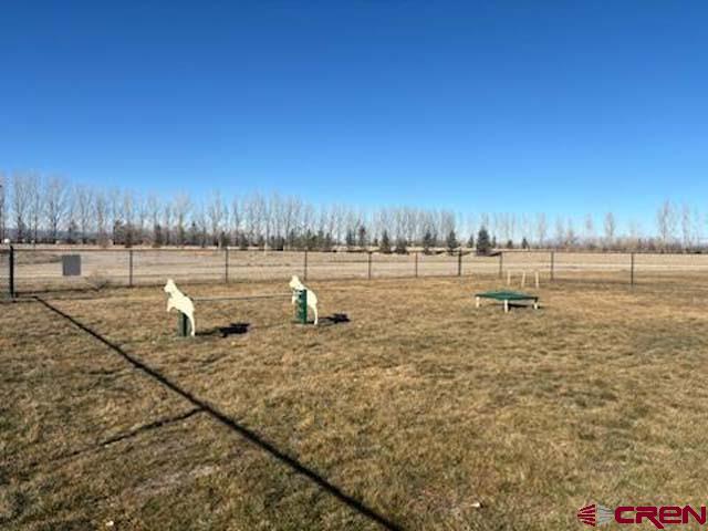 901 6530 Road, Unit 2813 Montrose, CO 81401 - Photo 28 of 34 a view of a lake with an outdoor space and seating area