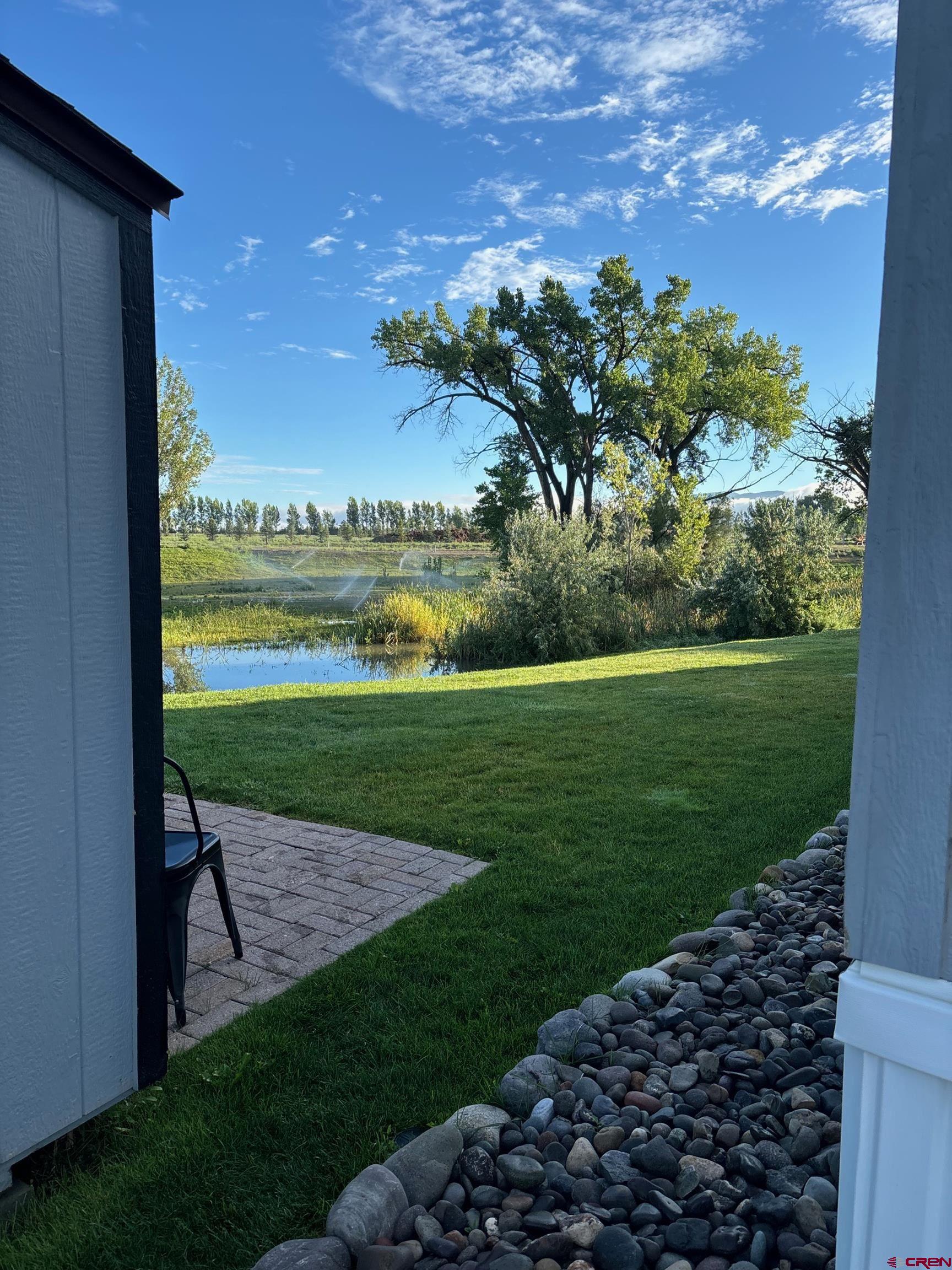 901 6530 Road, Unit 2813 Montrose, CO 81401 - Photo 31 of 34 a view of a garden with a lake