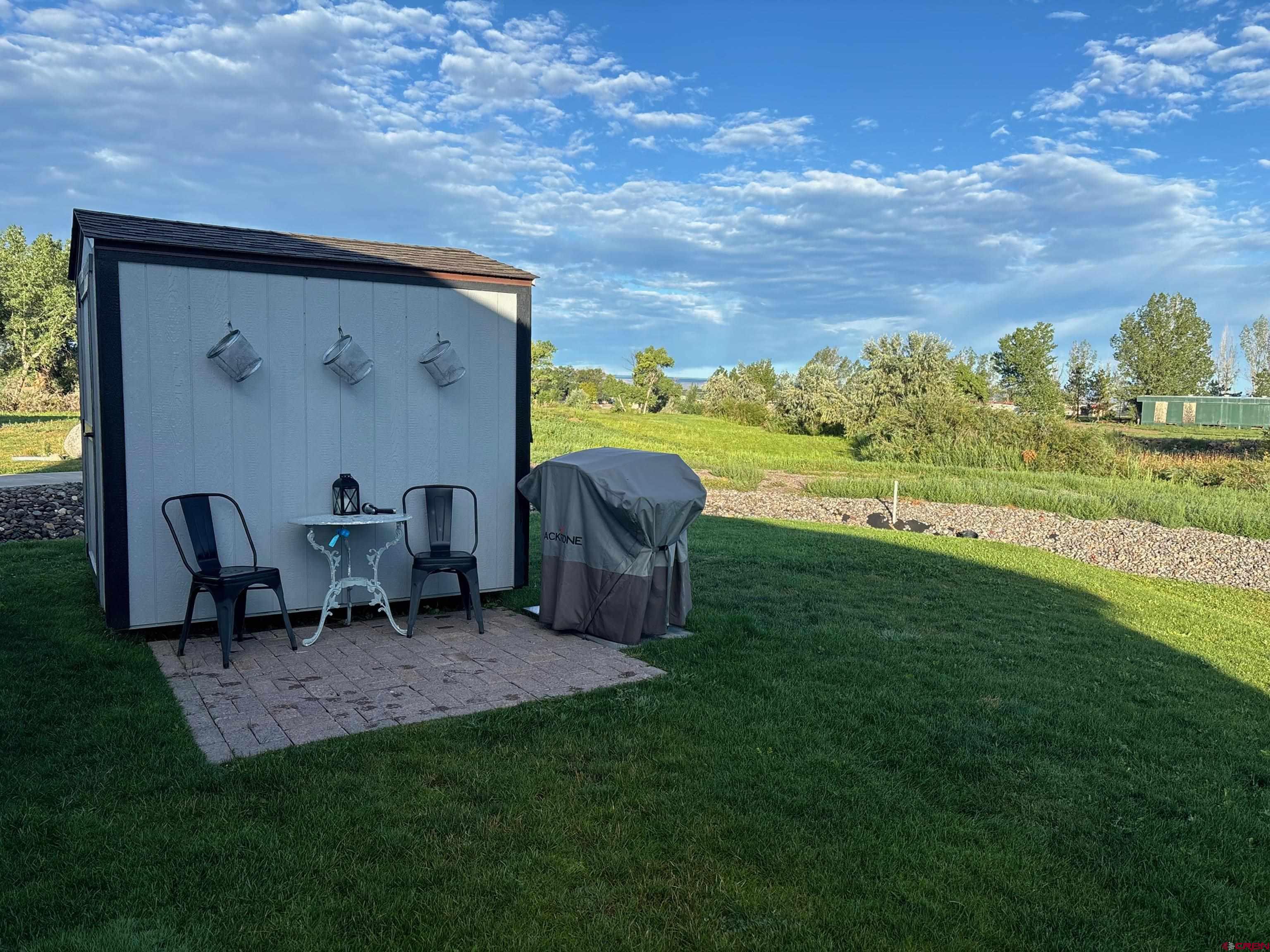 901 6530 Road, Unit 2813 Montrose, CO 81401 - Photo 32 of 34 a view of a two chairs in a big yard