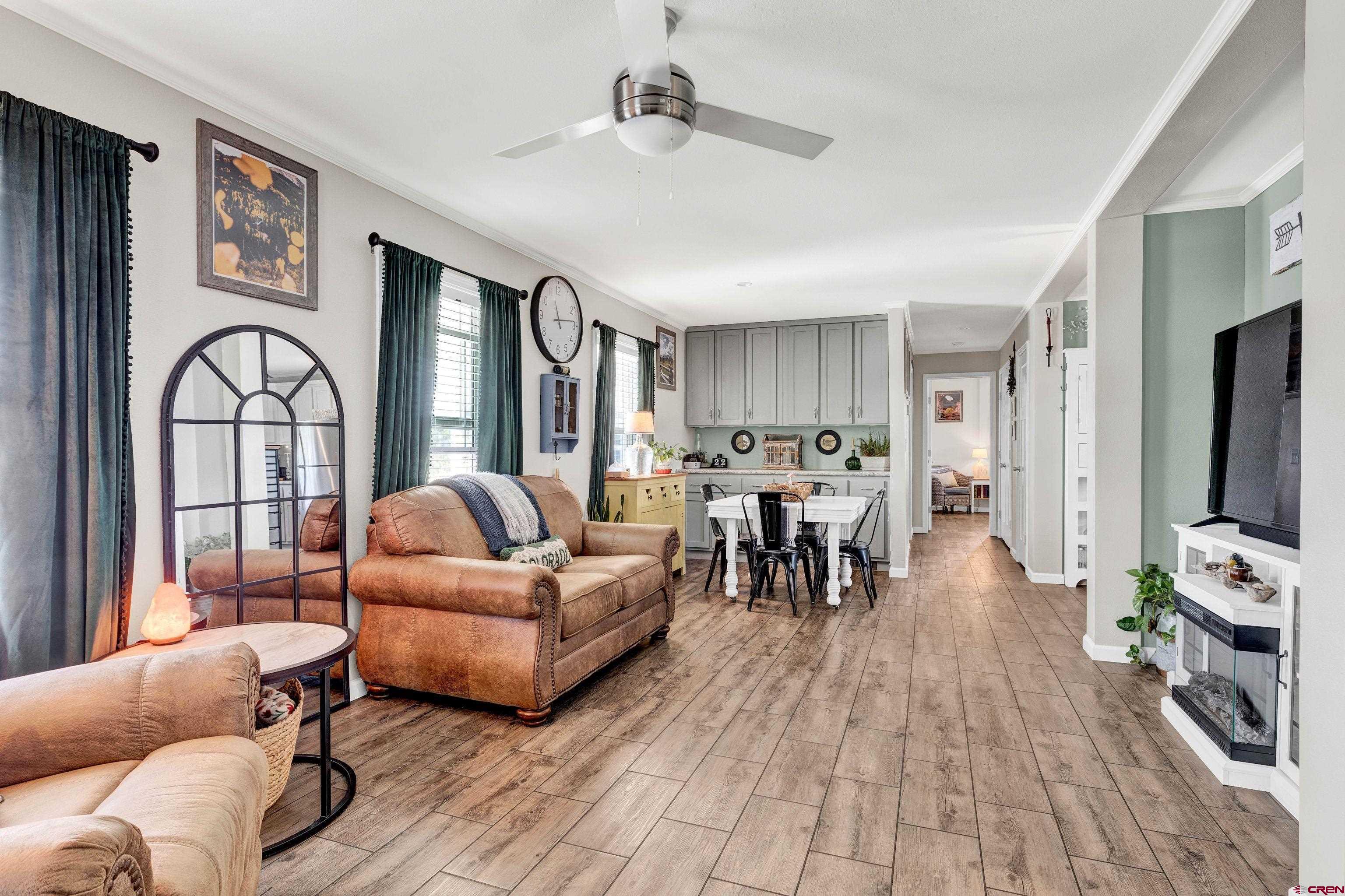 901 6530 Road, Unit 2813 Montrose, CO 81401 - Photo 6 of 34 a living room with furniture and a flat screen tv