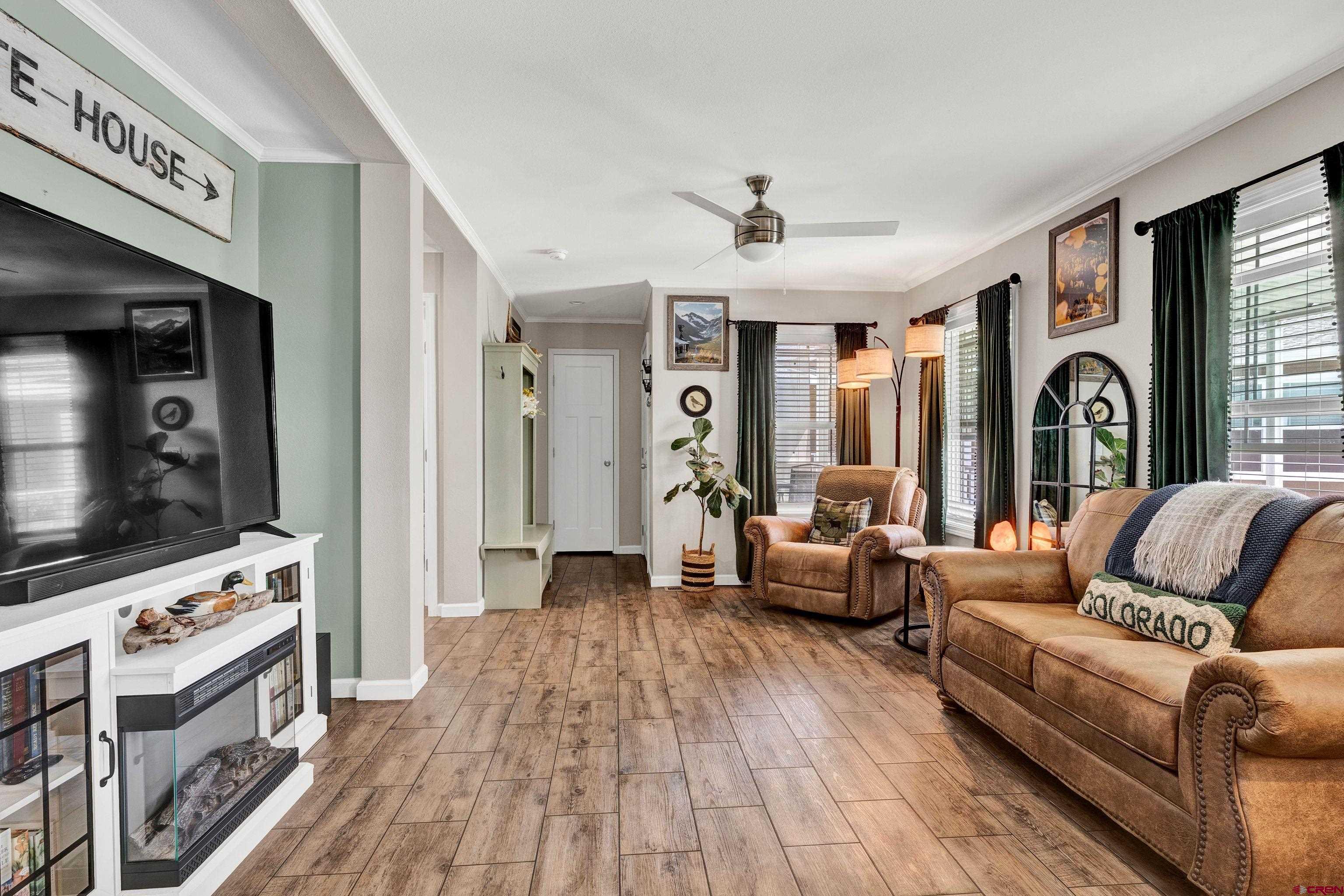 901 6530 Road, Unit 2813 Montrose, CO 81401 - Photo 7 of 34 a living room with furniture and a flat screen tv