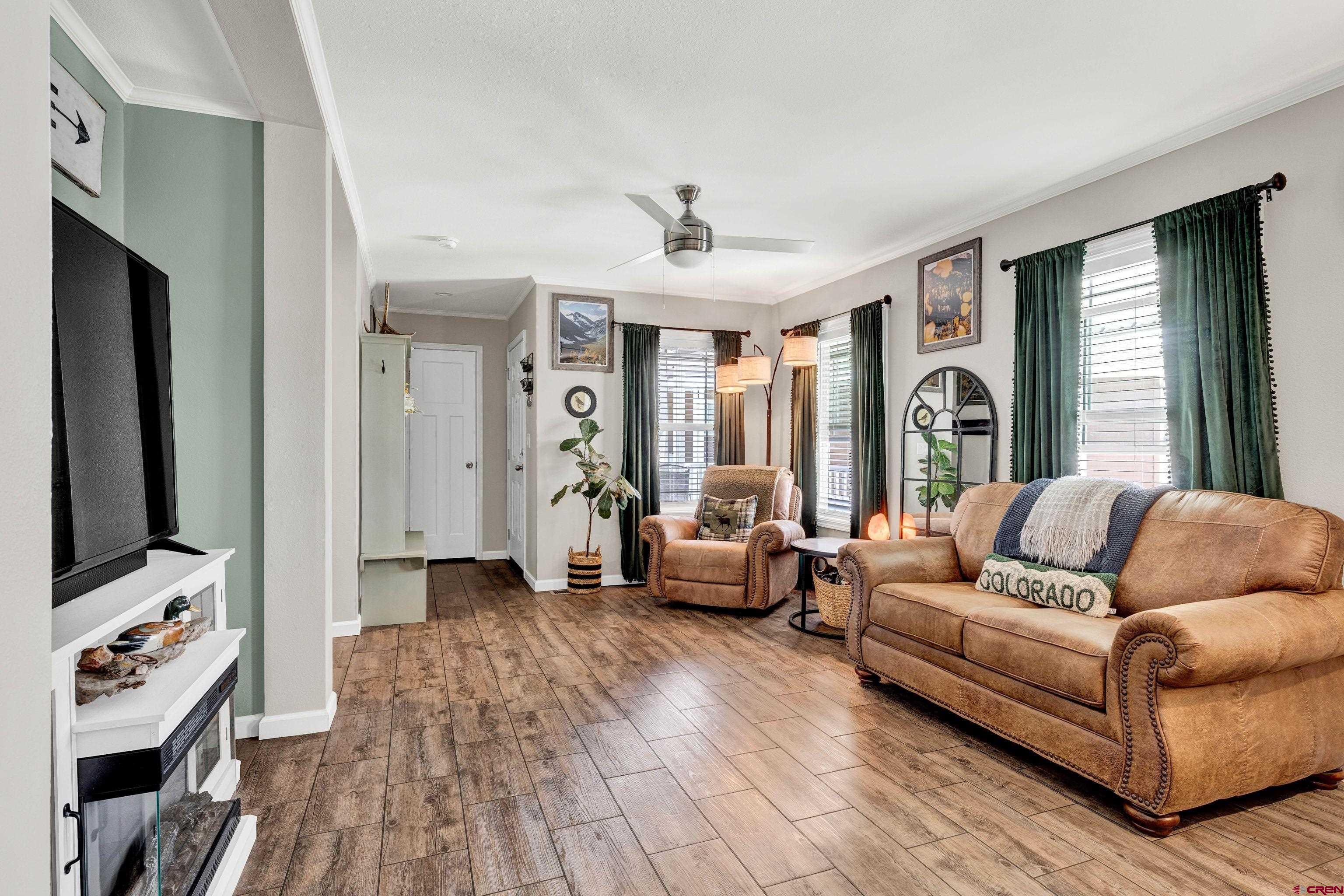 901 6530 Road, Unit 2813 Montrose, CO 81401 - Photo 8 of 34 a living room with furniture and a flat screen tv