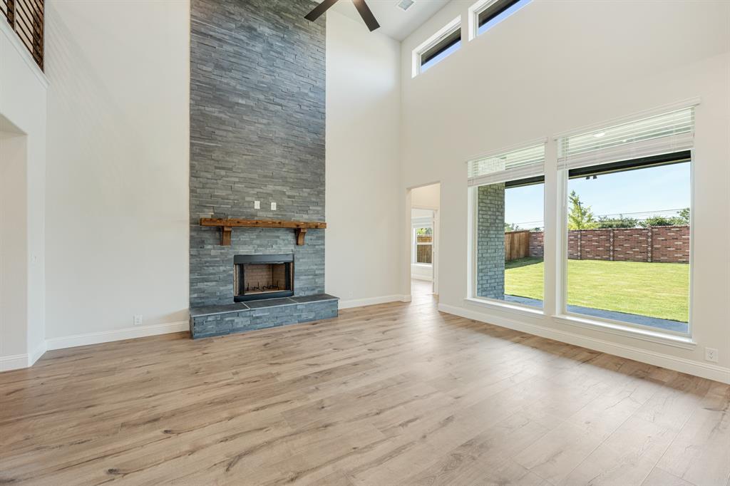 729 Seahawk Street Joshua, TX 76058 - Photo 11 of 40 a view of an empty room with wooden floor and a window