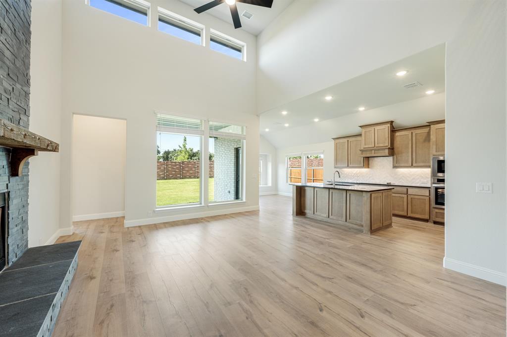 729 Seahawk Street Joshua, TX 76058 - Photo 13 of 40 a view of large kitchen with kitchen island stainless steel appliances wooden floor and window