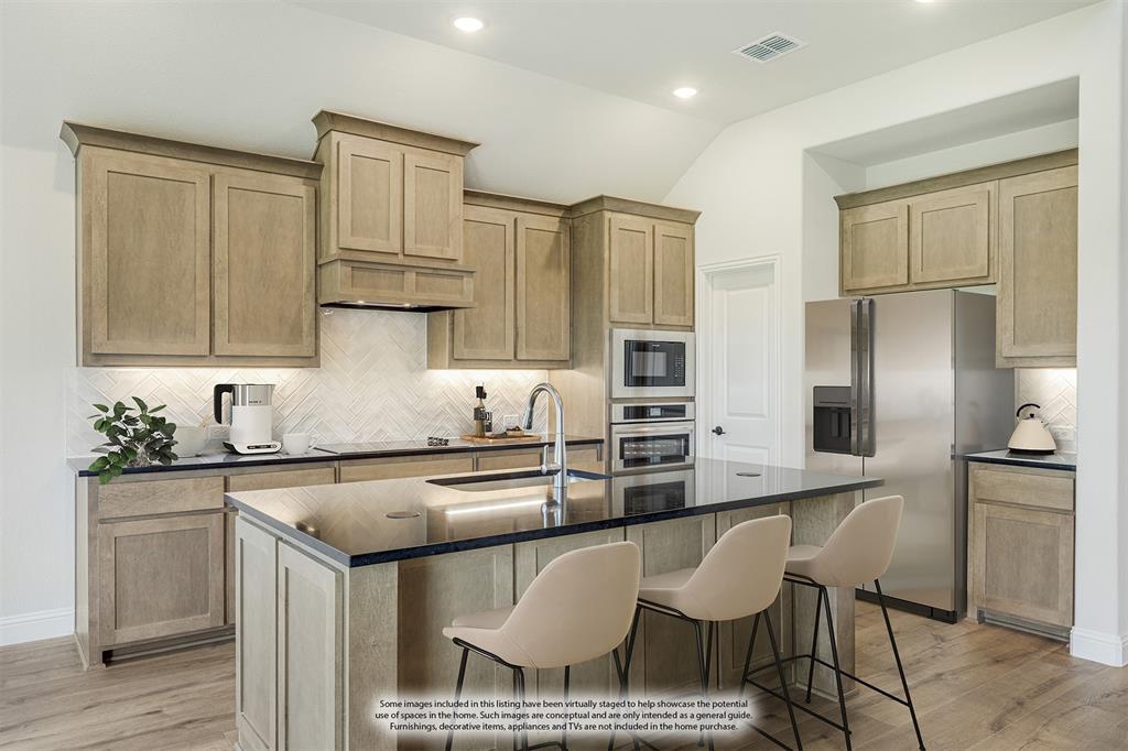 729 Seahawk Street Joshua, TX 76058 - Photo 16 of 40 a kitchen with stainless steel appliances granite countertop a sink a stove a refrigerator cabinets and chairs