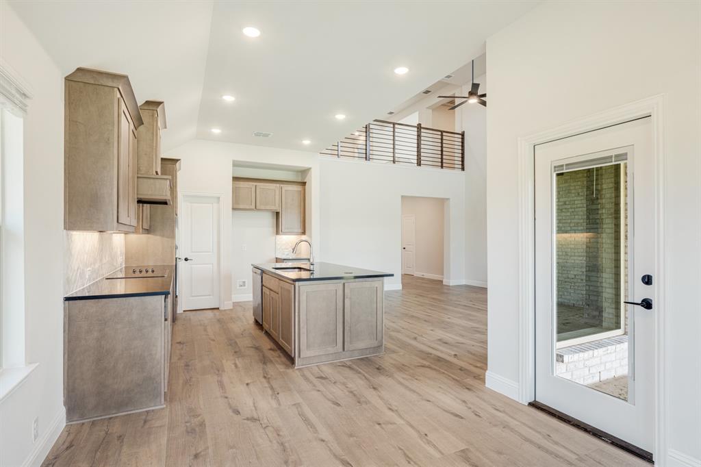 729 Seahawk Street Joshua, TX 76058 - Photo 18 of 40 a kitchen with a refrigerator and a sink