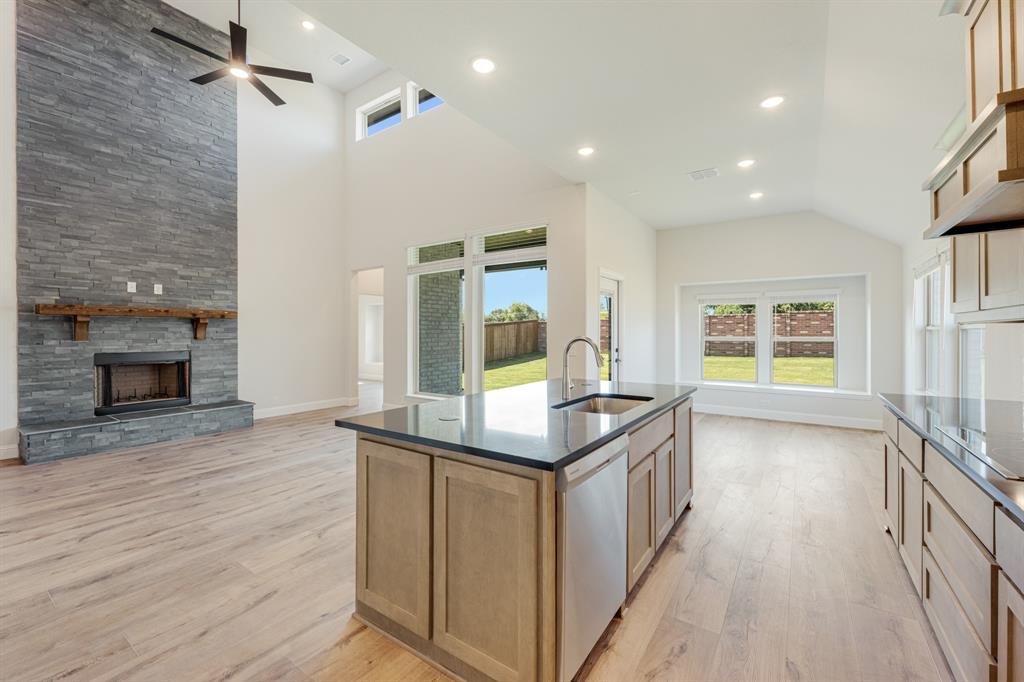 729 Seahawk Street Joshua, TX 76058 - Photo 19 of 40 a kitchen with kitchen island and wooden floor