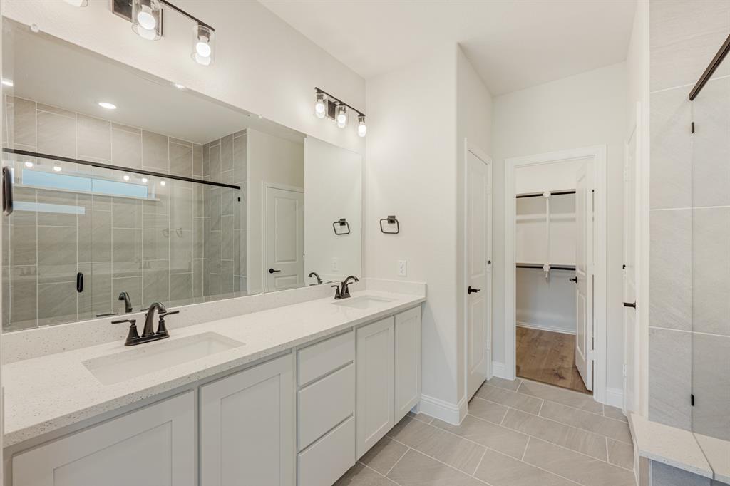 729 Seahawk Street Joshua, TX 76058 - Photo 23 of 40 a bathroom with a double vanity sink mirror and shower
