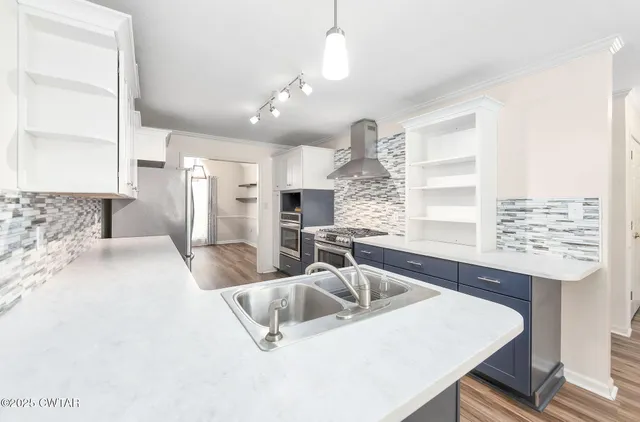 a large white kitchen with a large window