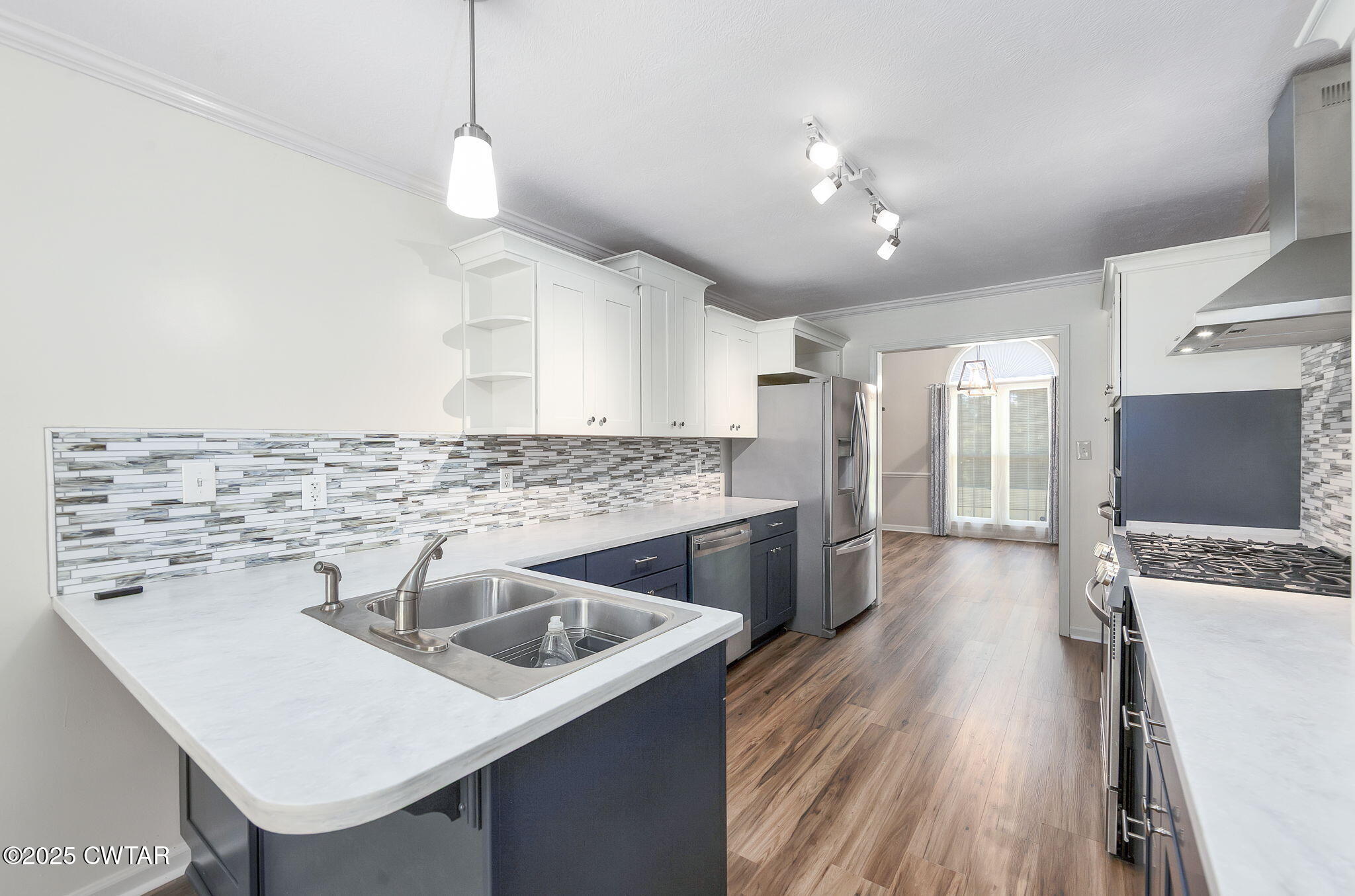 463 MCO Road Jackson, TN 38305 - Photo 12 of 36 a kitchen with a sink a counter top space stainless steel appliances and cabinets