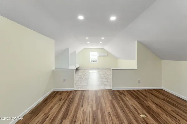 a view of an empty room and wooden floor
