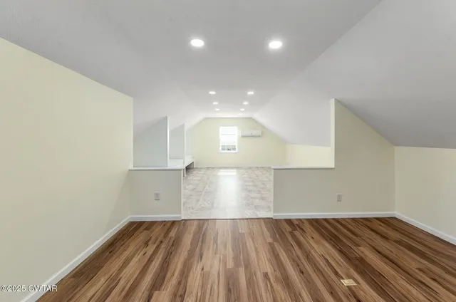 a view of an empty room and wooden floor