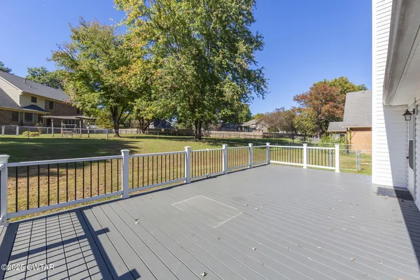 a view of a backyard with large tree