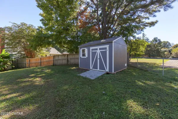 a house view with swimming pool in front of it