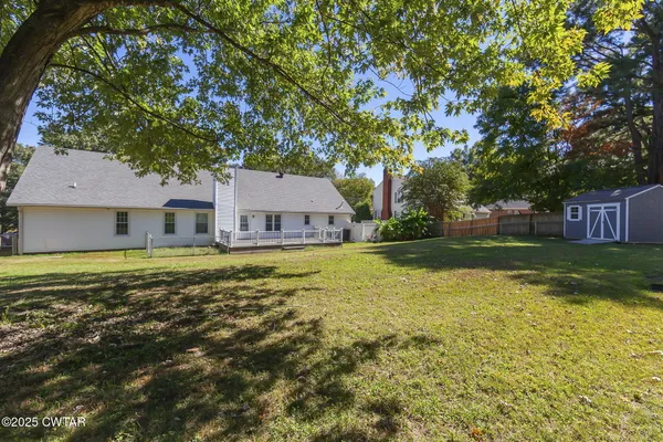 a swimming pool with outdoor seating and yard