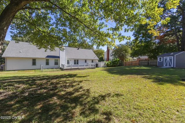 a swimming pool with outdoor seating and yard
