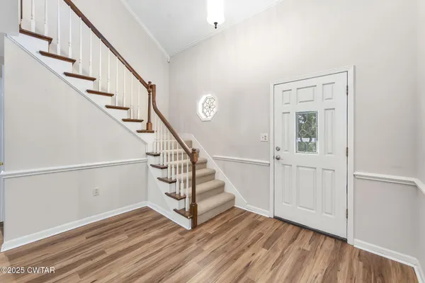 a view of entryway with wooden floor and stairs
