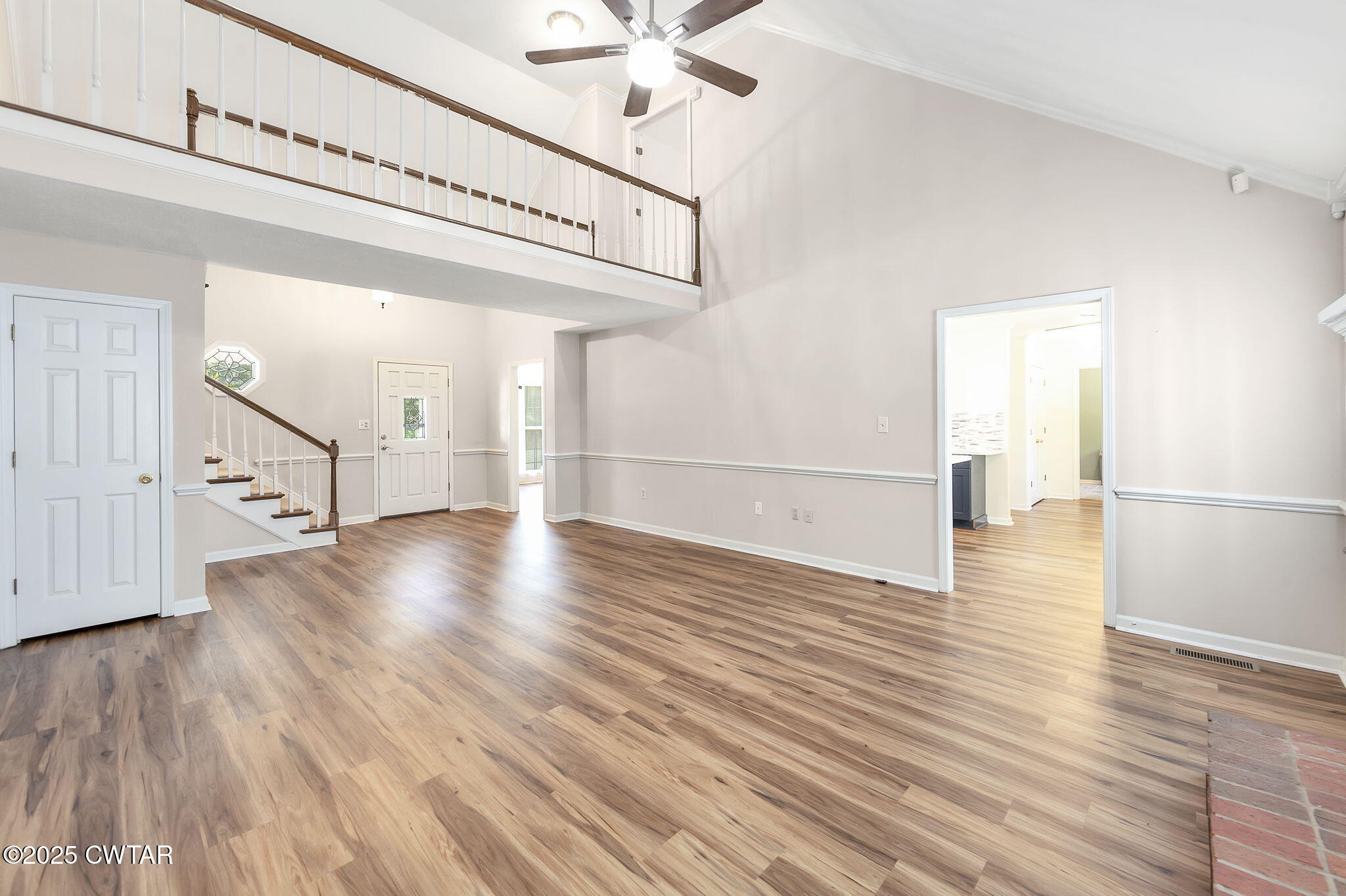 463 MCO Road Jackson, TN 38305 - Photo 9 of 36 a view of a room with wooden floor a ceiling fan and windows