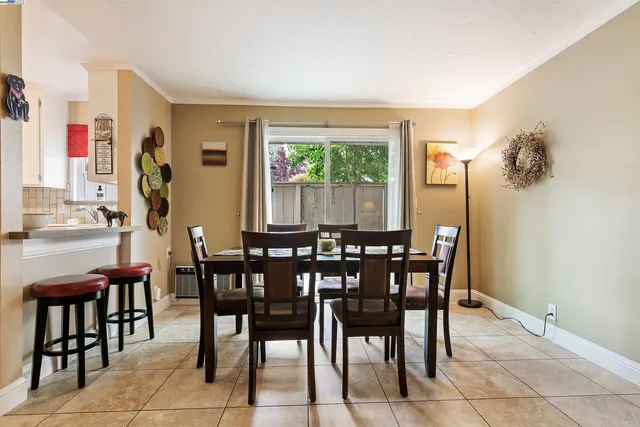 a view of a dining room with furniture and a potted plant