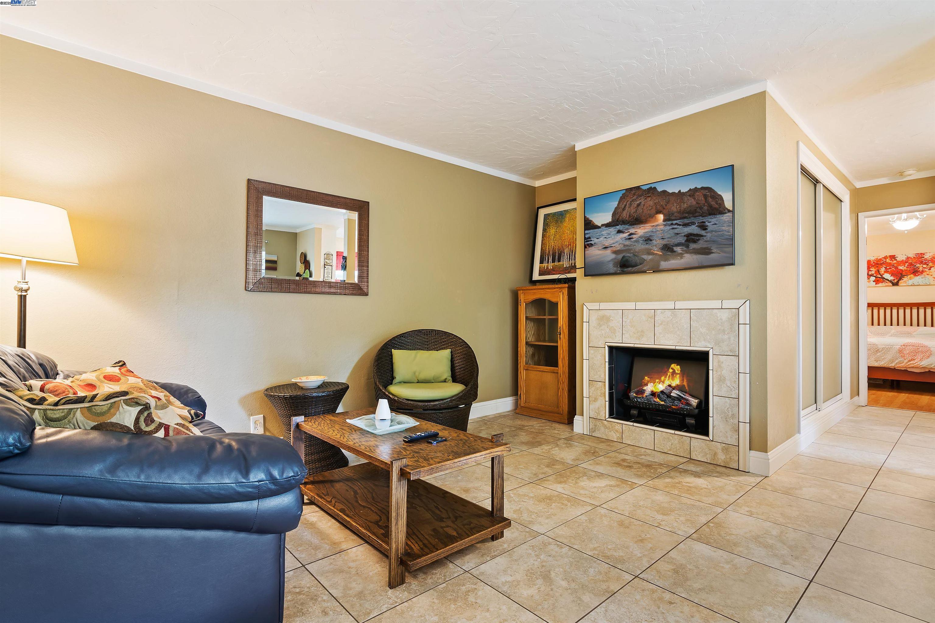 385 Camelback Road, Unit 2 Pleasant Hill, CA 94523 - Photo 4 of 19 a living room with furniture a fireplace and a large mirror