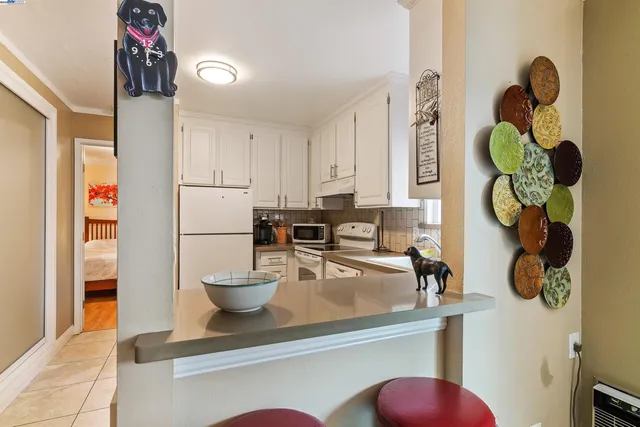 a kitchen with a refrigerator and a sink
