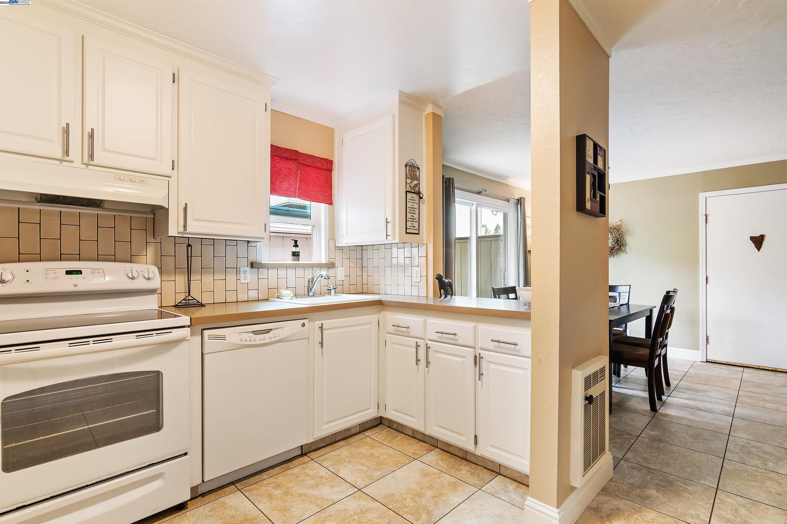 385 Camelback Road, Unit 2 Pleasant Hill, CA 94523 - Photo 8 of 19 a kitchen with a stove a sink and white cabinets