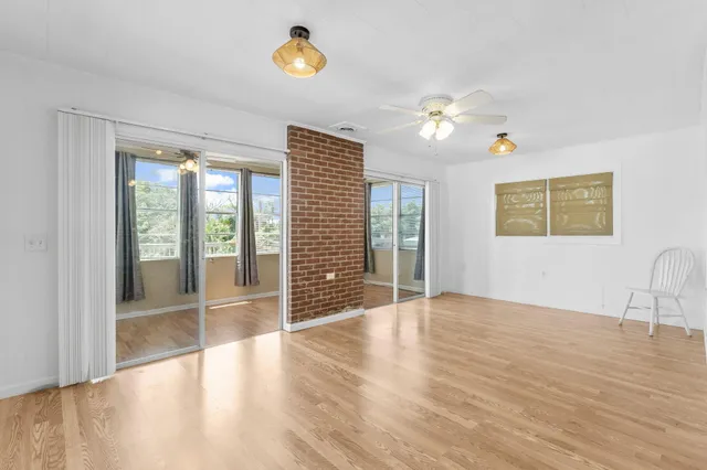 a view of a kitchen with wooden floor and a kitchen space