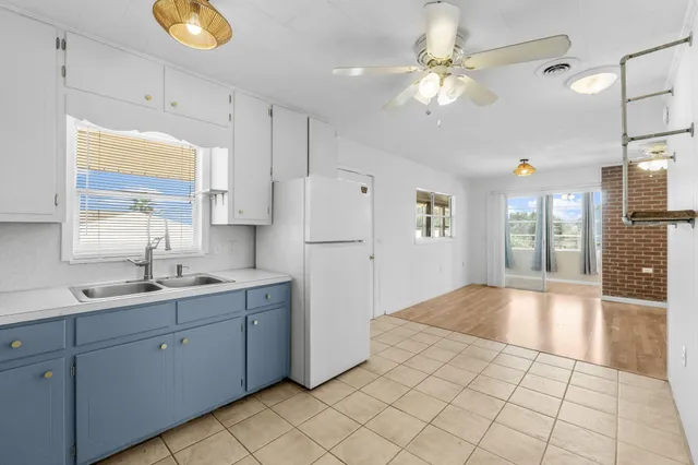 a kitchen with a sink a refrigerator and a stove