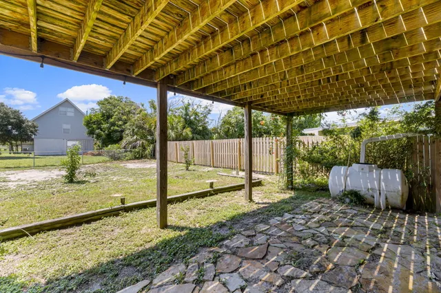 a view of a house with a yard and porch