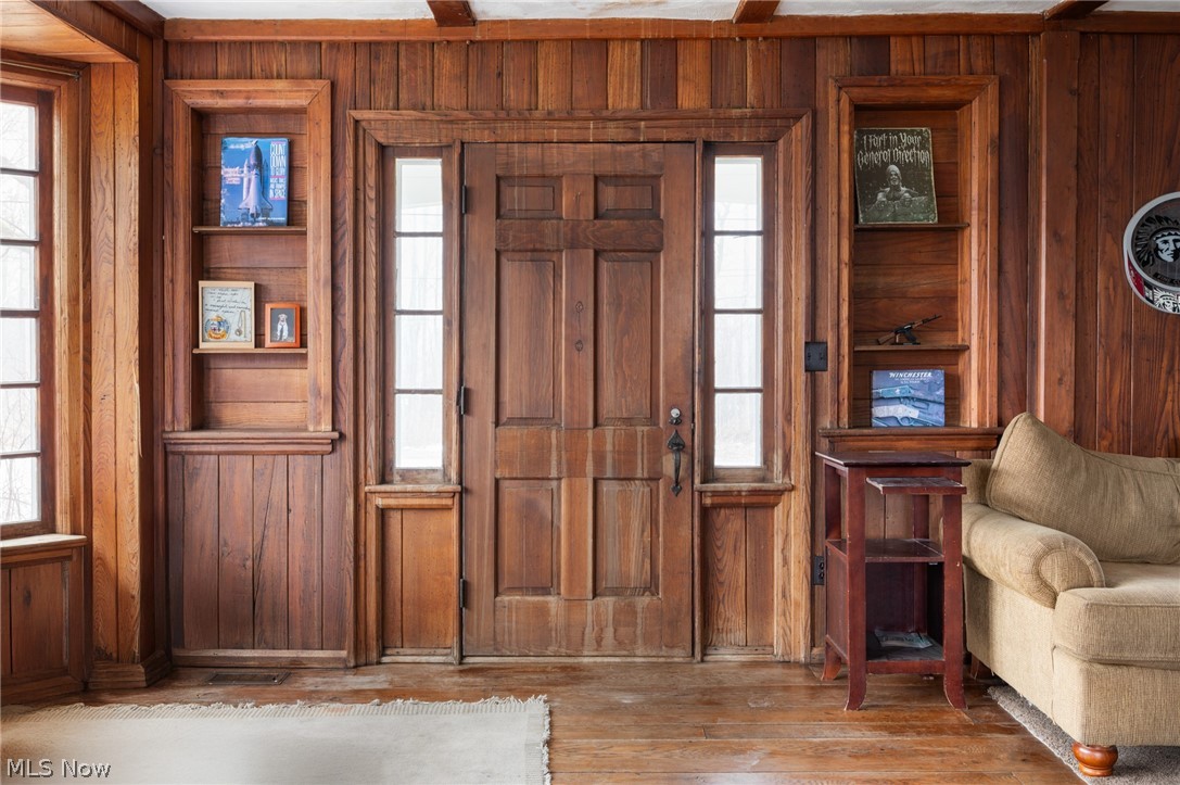 9455 Robinson Road Chardon, OH 44024 - Photo 2 of 33 Foyer entrance featuring wood walls, hardwood / wood-style flooring, and plenty of natural light