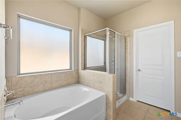 a bathroom with a granite countertop sink a large mirror and a shower