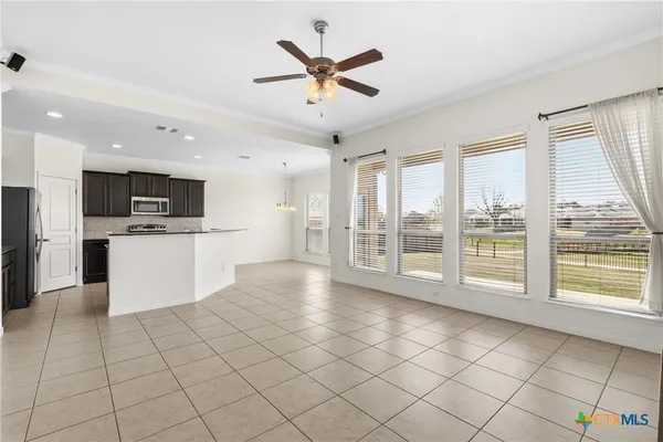 a view of a kitchen with microwave and refrigerator