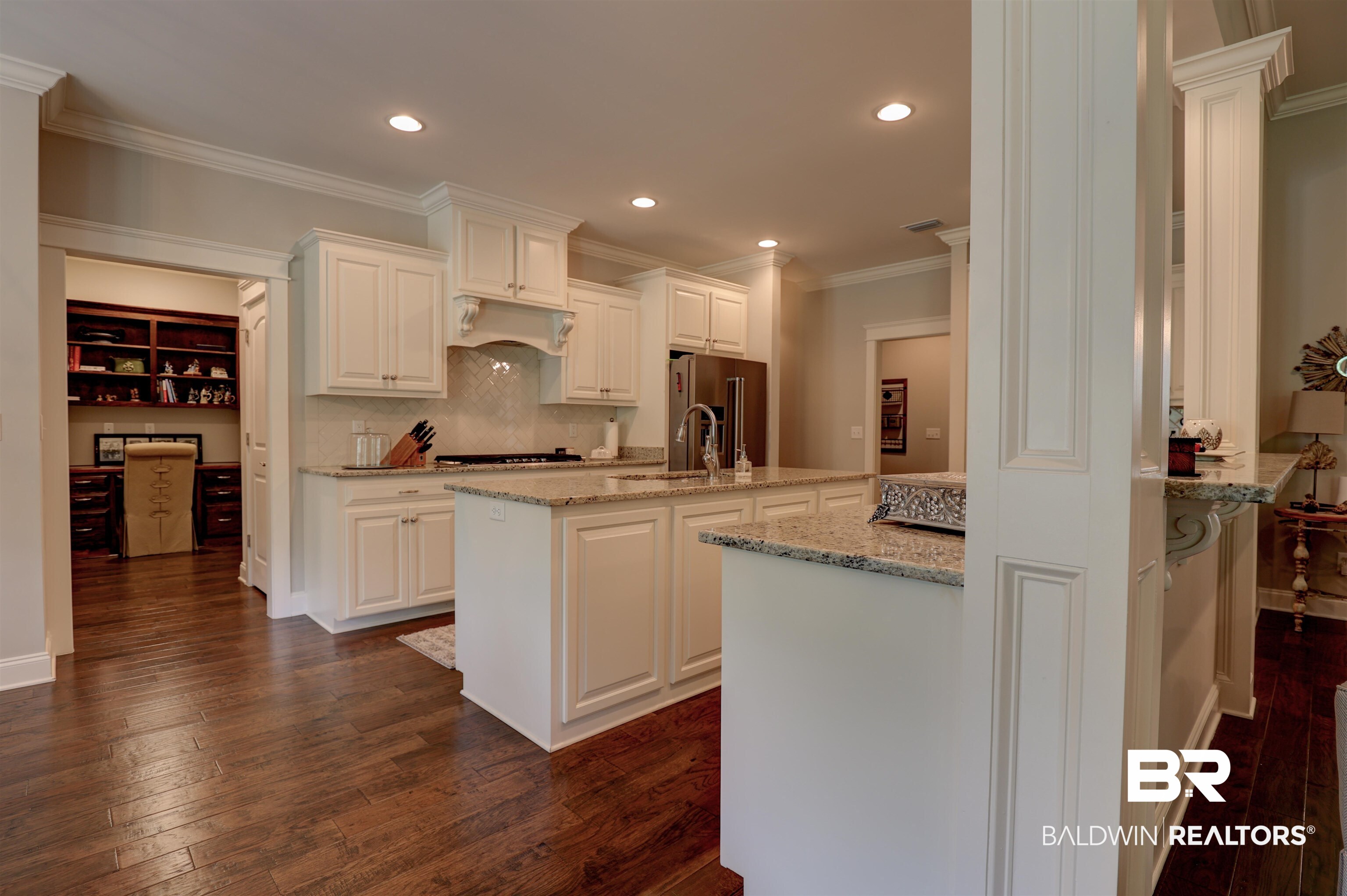 10588 Leesburg Pike Daphne, AL 36526 - Photo 11 of 29 Kitchen featuring white cabinets, dark wood-type flooring, crown molding, and high quality fridge